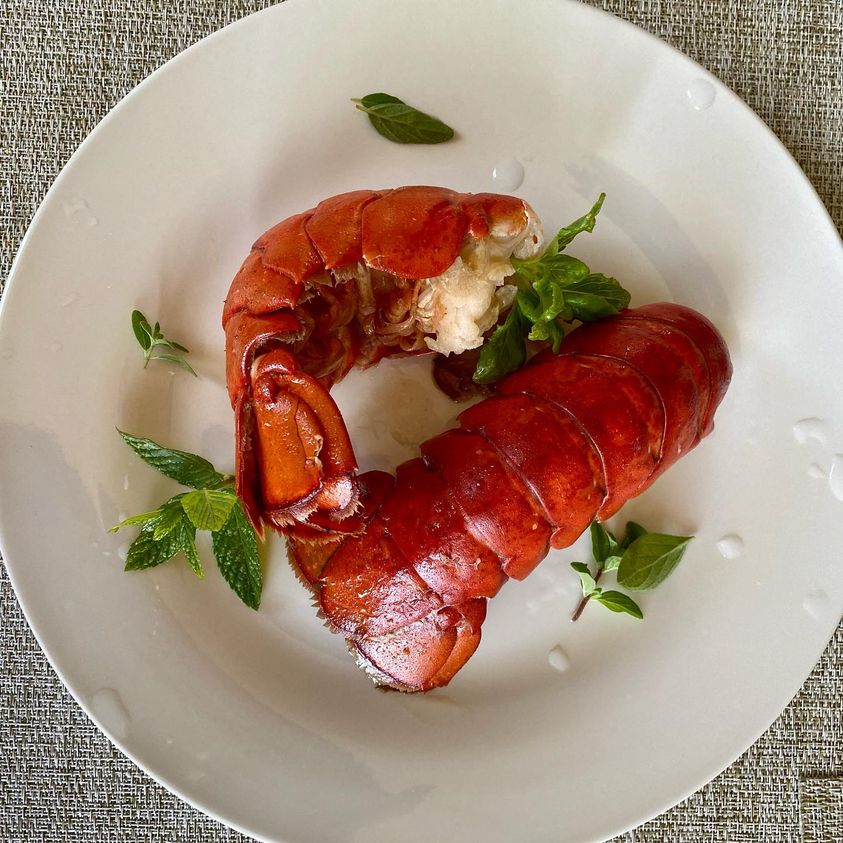 Steamed lobsters in garlic flavored butter